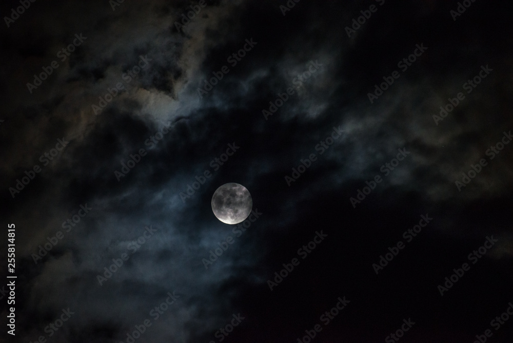 Moon through the clouds at night, super moon Moon through the clouds at night, super moon
