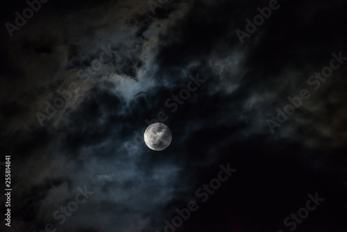 Fotografia Moon through the clouds at night, super moon
