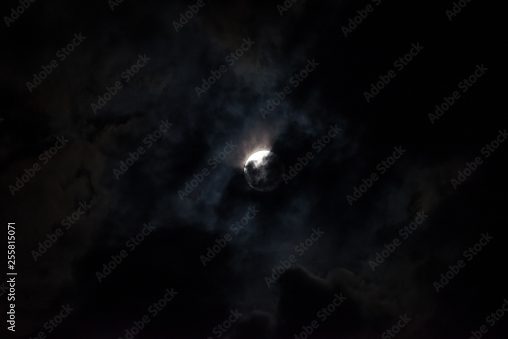 Moon through the clouds at night, super moon