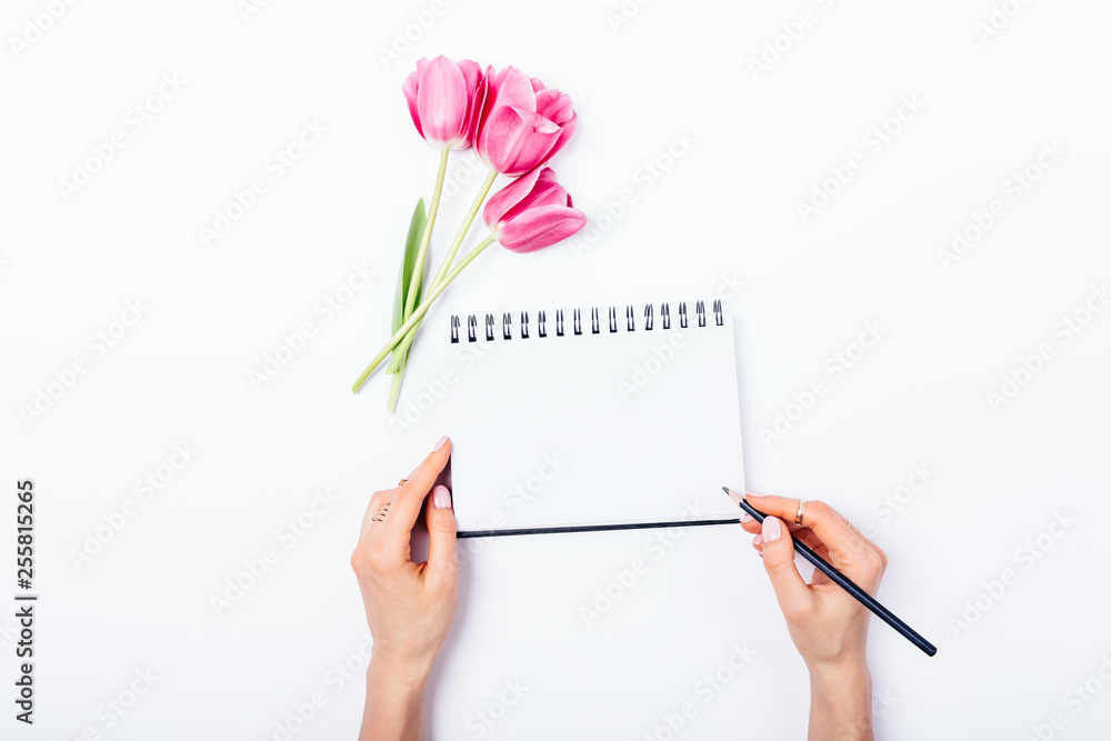 Top view female's hands writing Top view female's hands writing