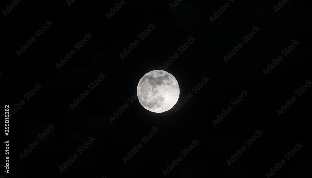 Moon through the clouds at night, super moon Moon through the clouds at night, super moon