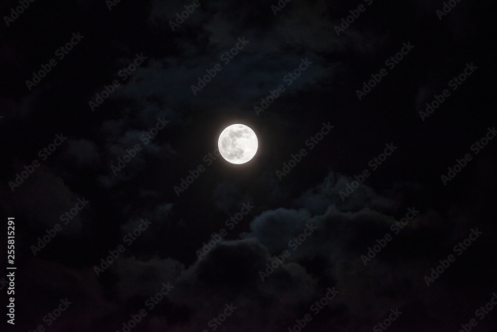 Moon through the clouds at night, super moon