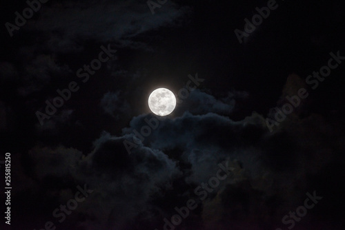 Moon through the clouds at night, super moon