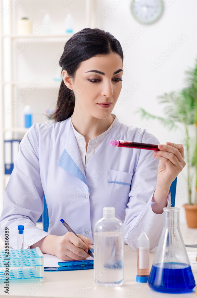 Young female chemist working in the lab Young female chemist working in the lab