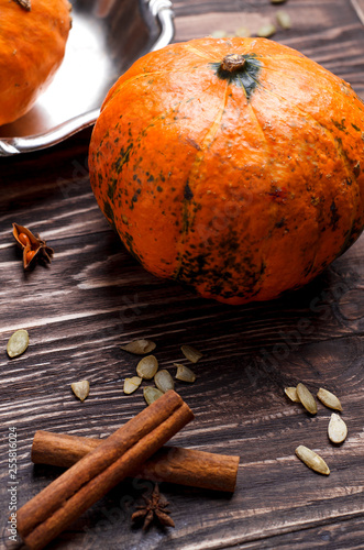 Close-up of pumpkins and spices around it. Aromatic utumn dish, cooking process
