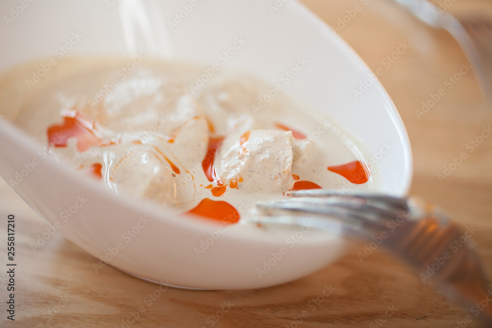 Chicken fillet in a cream sauce in a white dish Chicken fillet in a cream sauce in a white dish
