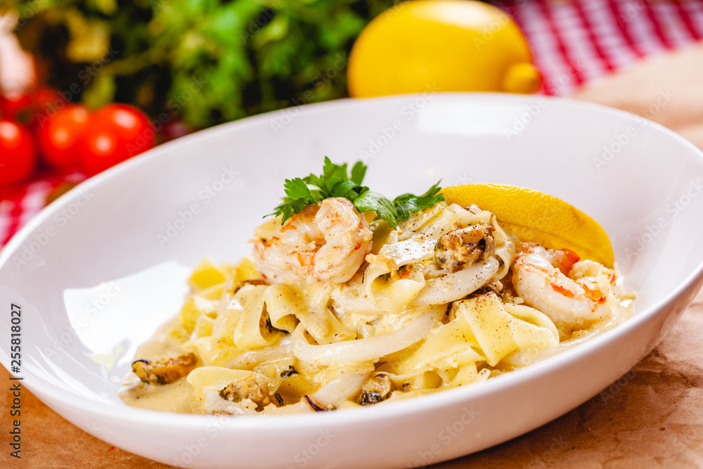 Italian pasta with seafood on white plate. Close up