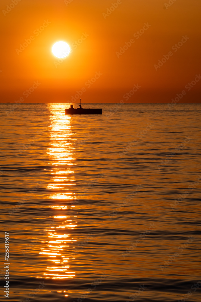 Silhouette of big buoy from sunset sunshine in Trieste, Italy Silhouette of big buoy from sunset sunshine in Trieste, Italy