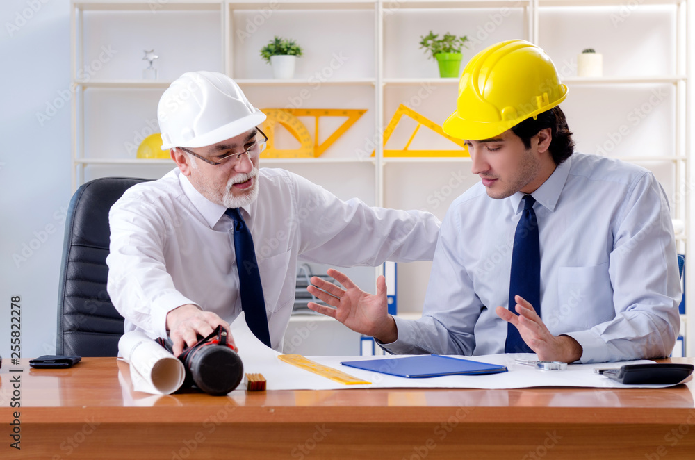 Two engineers colleagues working under project Two engineers colleagues working under project