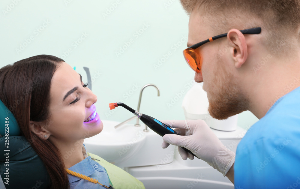 Professional dentist working with patient in modern clinic. Teeth whitening Professional dentist working with patient in modern clinic. Teeth whitening