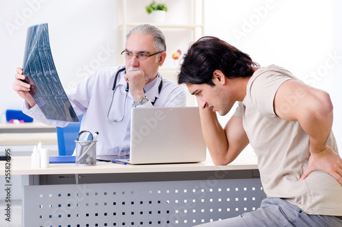 Young man visiting old male doctor radiologist 