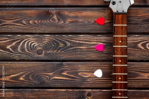 Musician work place with guitar on wooden background top view mock up