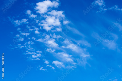 cloud formations in the shiny blue sky