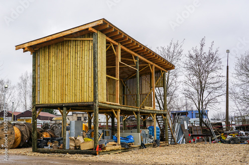 new wooden warehouse on a high base in the construction process © Zigmunds