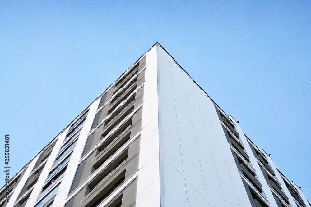 Multistory new modern apartment building. Stylish living block of flats. Modern, new executive apartments and with deep blue summer sky