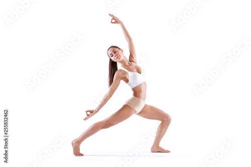 Woman working yoga exercise, full-length portrait, isolated on white. Balance and meditation.