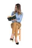 relaxed fascinated businesswoman reads while sitting