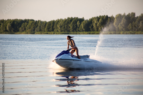 young girl riding a water scooter