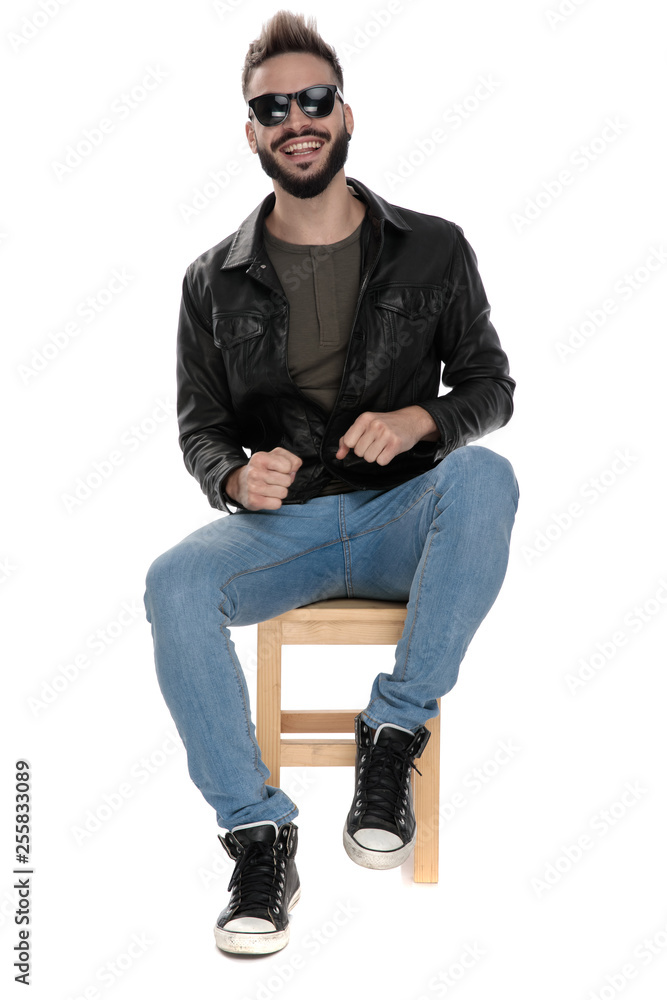 man in black jacket and blue jeans laughing man in black jacket and blue jeans laughing