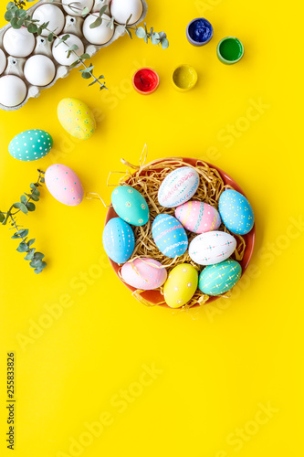 Traditional Easter eggs for paint on yelow background top view