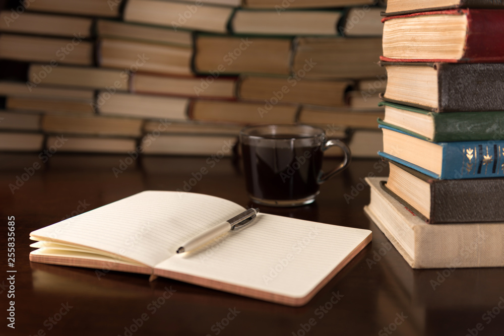 Naklejka premium open notebook and cup on the desktop