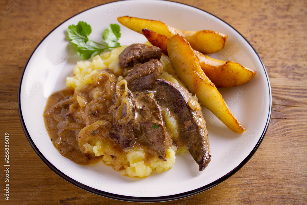 Liver with pears and cream and wine onion sause on mashed potato. horizontal Liver with pears and cream and wine onion sause on mashed potato. horizontal