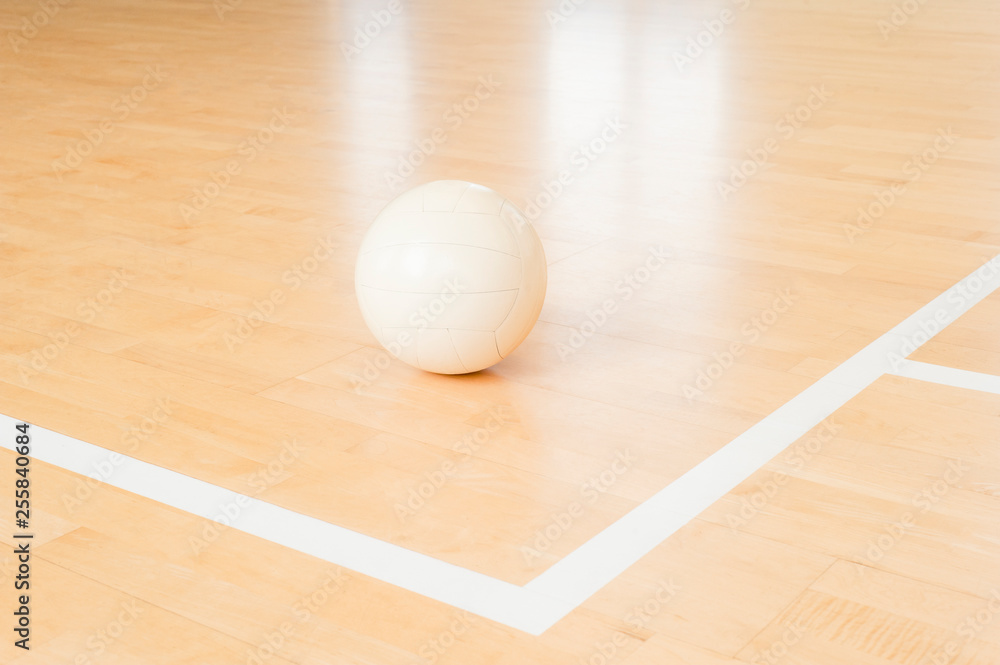 White volleyball on the floor in the gym White volleyball on the floor in the gym