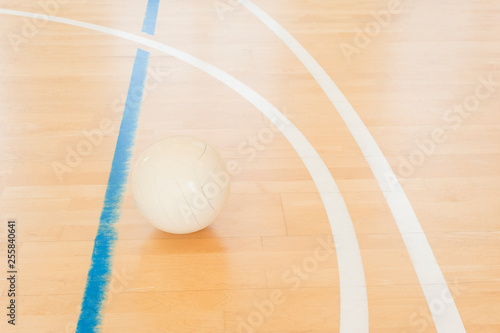 White volleyball on the ground in the school gym