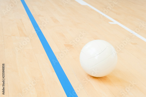 White volleyball on the floor in the gym