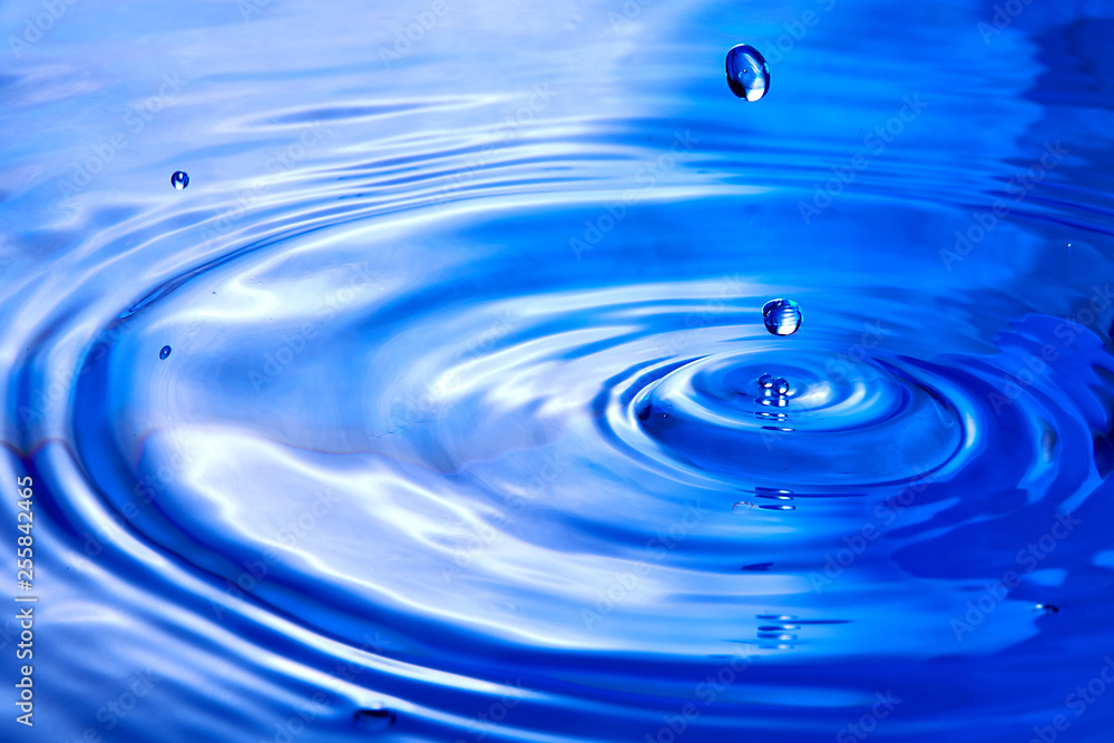 close up of drop in water making different splashes close up of drop in water making different splashes