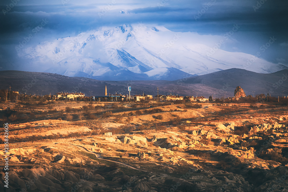 Mount Erciyes (The Erjiyas Volcano) is a symbol of Kayseri and Cappadocia. View from the town of Goreme at sunset. Majestic Mountain view, Turkey.
