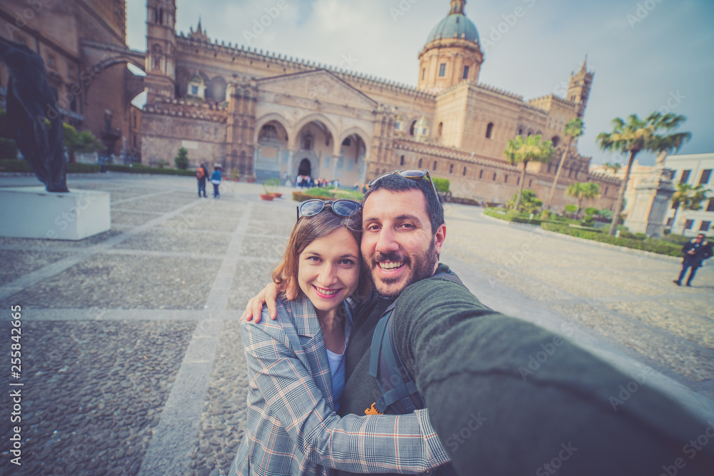 happy tourist couple traveling in Palermo, Sicily and taking selfie in . Italian holidays road trip