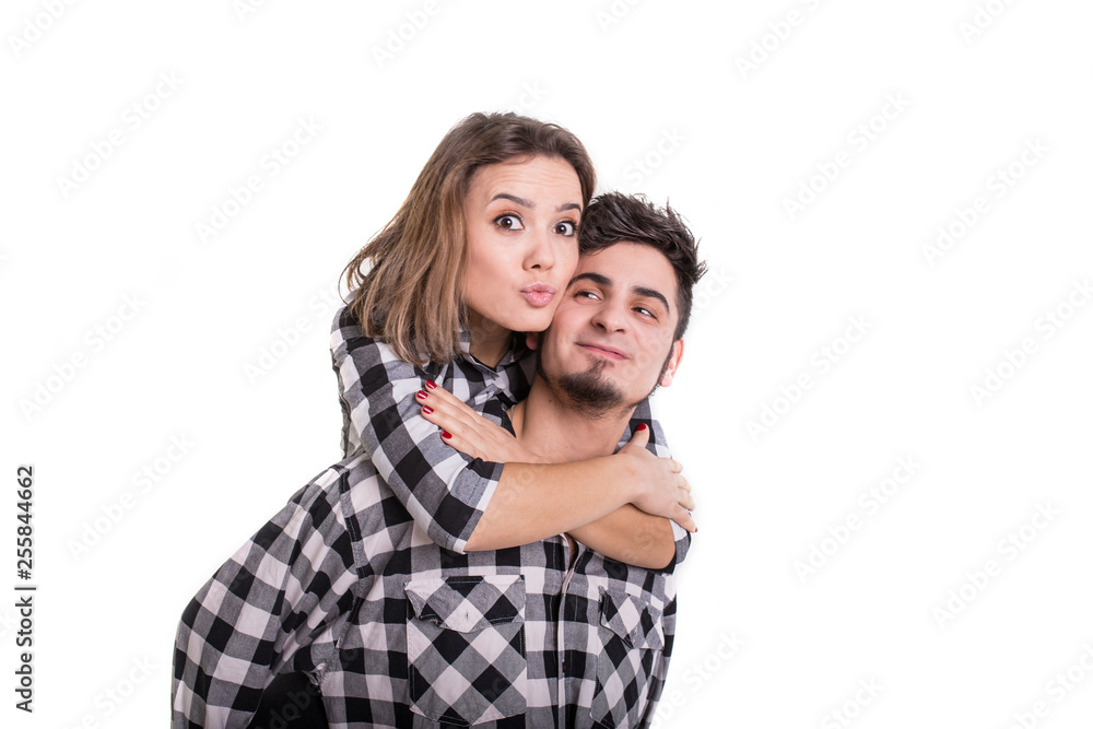 Girl on boy's back sending blowing kiss isolated Girl on boy's back sending blowing kiss isolated
