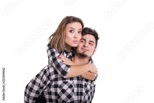 Girl on boy's back sending blowing kiss isolated