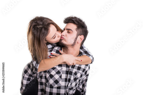 Happy young couple embracing each other and kissing isolated on white