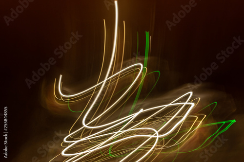 creative photography with unusual pattern of dancing light or neon in chaotic multi colored lines on abstract background. concept of unique desktop wallpaper or screensaver. copy space, texture, blur photo