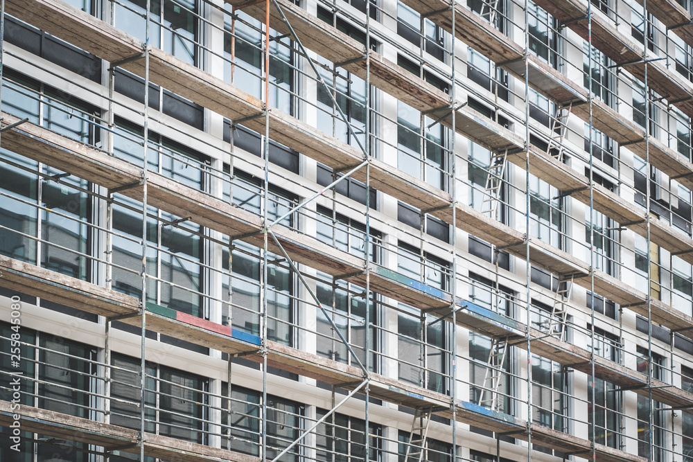 scaffolding on house facade,modern building under construction - scaffolding on house facade,modern building under construction -
