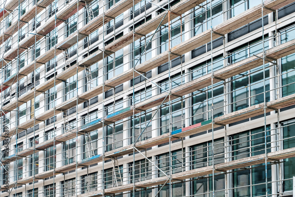 scaffolding on house facade, apartment builing under construction - scaffolding on house facade, apartment builing under construction -