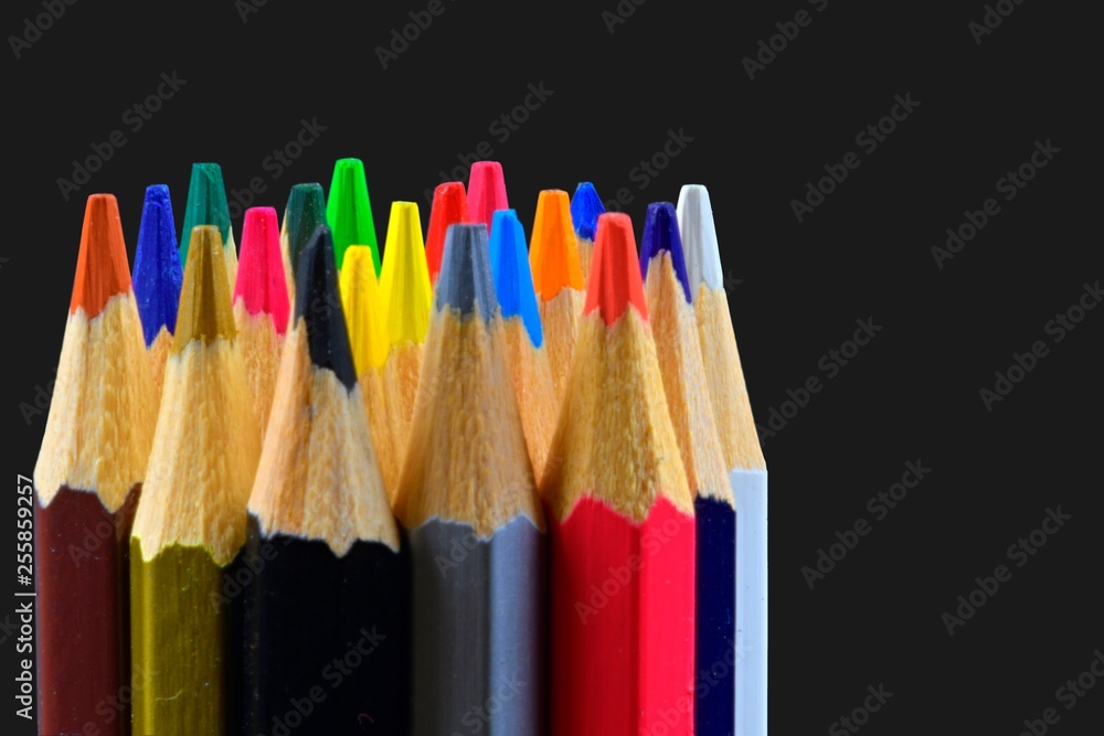 Closeup of colorful crayon pencils on black background with copy space. Back to school concept. Drawing concept. Free space for text Closeup of colorful crayon pencils on black background with copy space. Back to school concept. Drawing concept. Free space for text