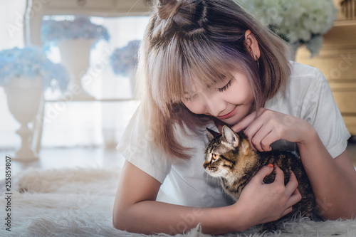 portrait of Asian female with cute cat © Mongkolchon