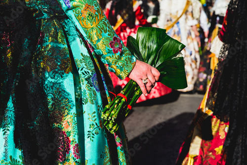 Valencia, Spain - March 17, 2019: Detail of the typical fallero dress, during the colorful and traditional parade of the offering, handmade embroidered dresses for the falleras. photo