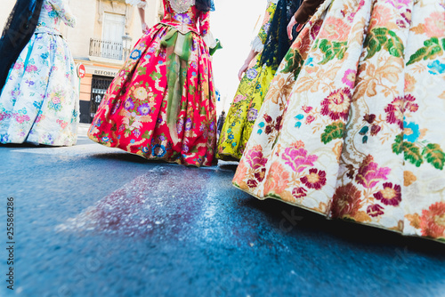 Valencia, Spain - March 17, 2019: Detail of the typical fallero dress, during the colorful and traditional parade of the offering, handmade embroidered dresses for the falleras. photo