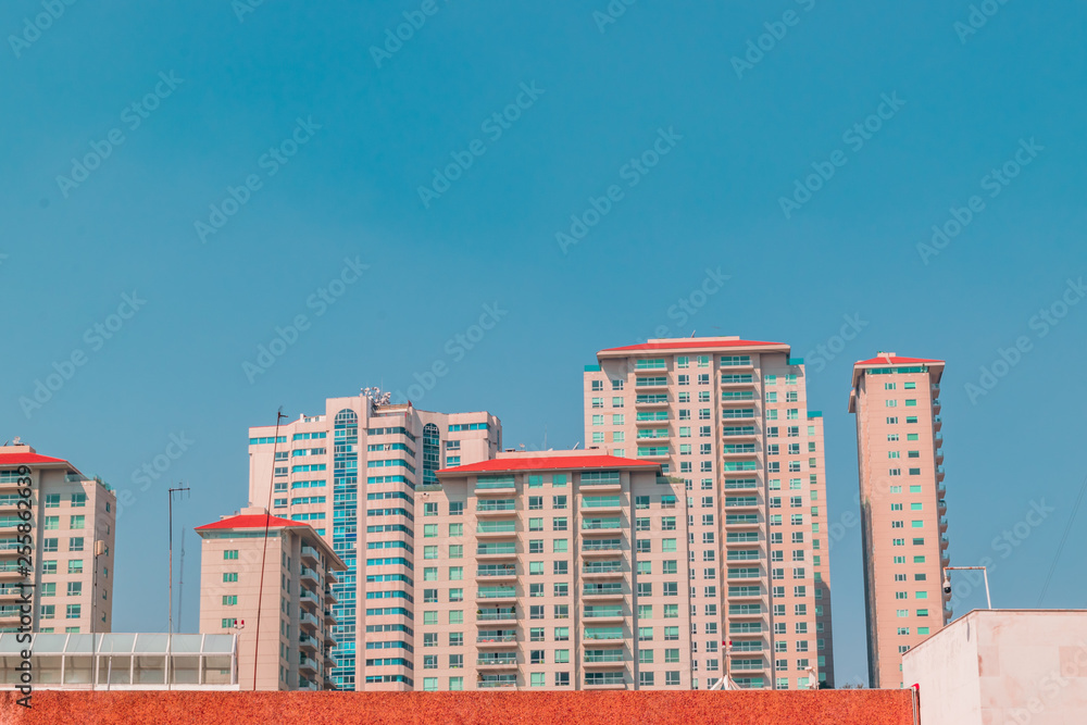 Full shot of orange apartments on blue sky Full shot of orange apartments on blue sky