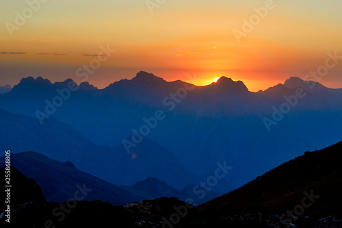 mountain silhouettes at the sunset, orange and red colors in the sky, Fann, Pamir Alay, Tajikistan