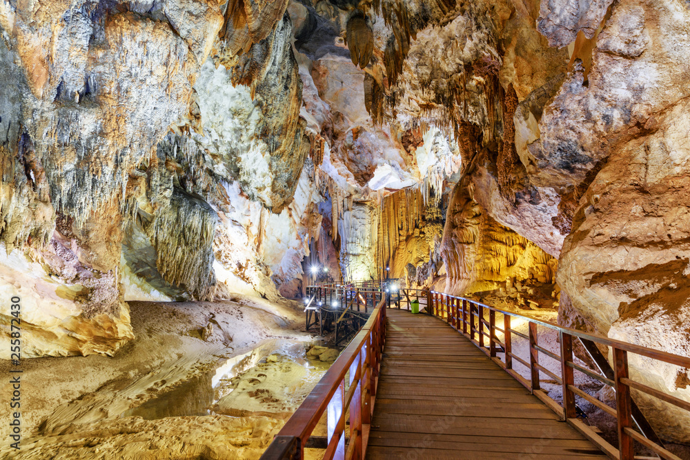 Wooden winding walkway among stalactites inside Paradise Cave
