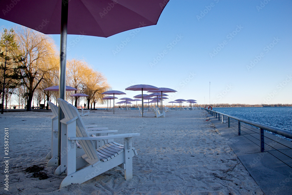 Beach chairs with umbrella in sunset colour