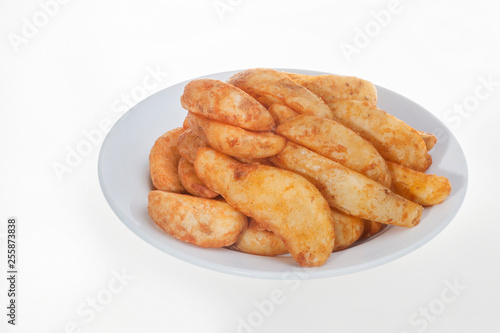 Close up of fried potatoes with plate
