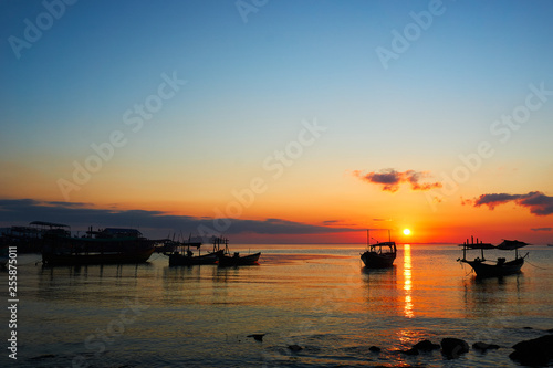 Beautiful sunrise on tropical beach Koh rong cambodia Landscape with longtail boats while sun is going up © Juergen
