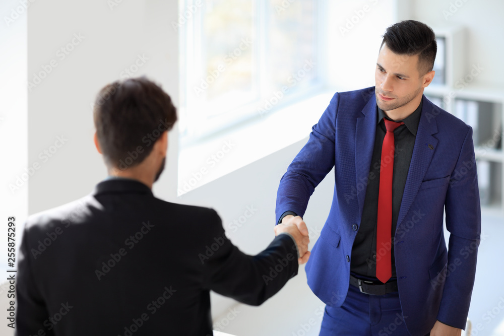 Business people shaking hands after good deal Business people shaking hands after good deal