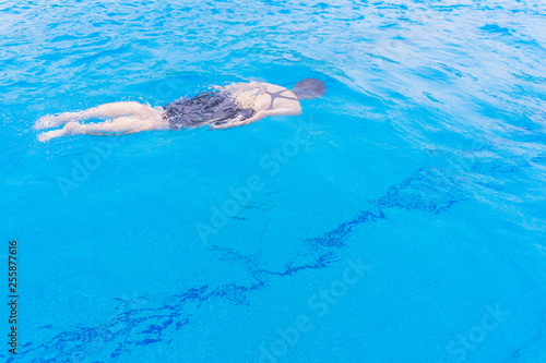 Swimming pool blue color clear water and people enjoying in summer sunny day and top view angle.